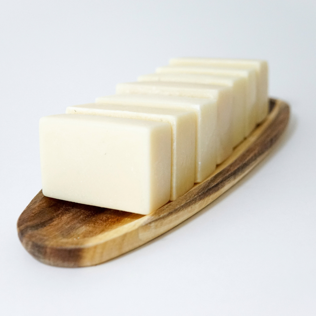 Eight Origin natural tallow soap bars arranged neatly on a tray for a lifestyle display.