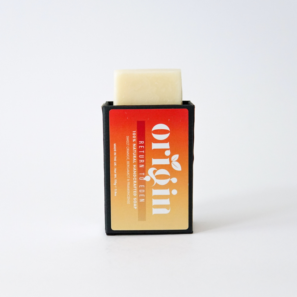 Sweet Orange, Bergamot & Frankincense soap bar partially popping out of its upright box.