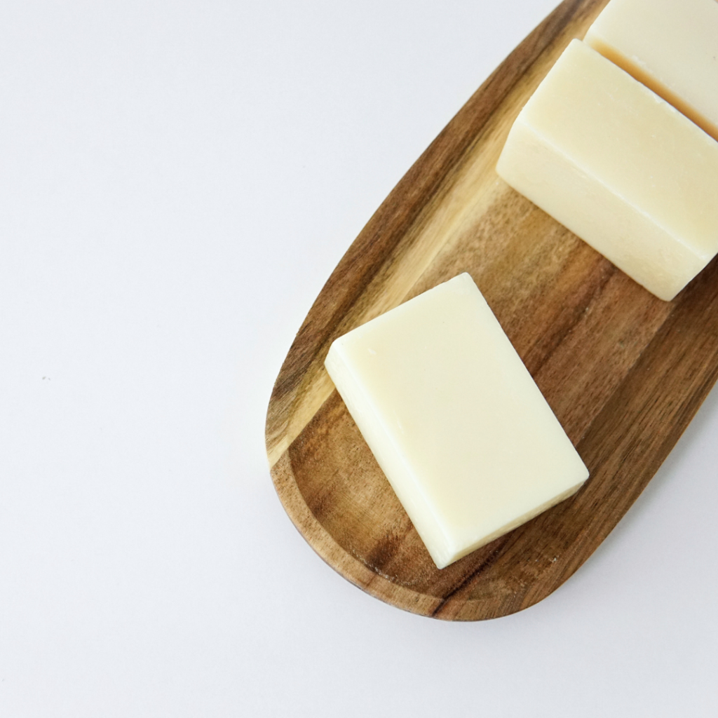 Multiple natural tallow soap bars displayed on a tray.