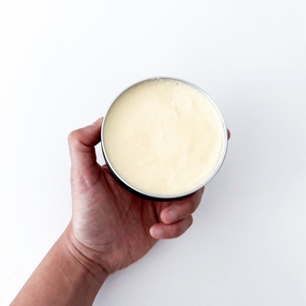 Bug Balm on bathroom vanity beside natural skincare items