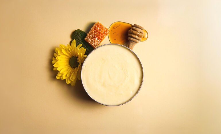 Whipped tallow and honey balm in glass jar with natural ingredients