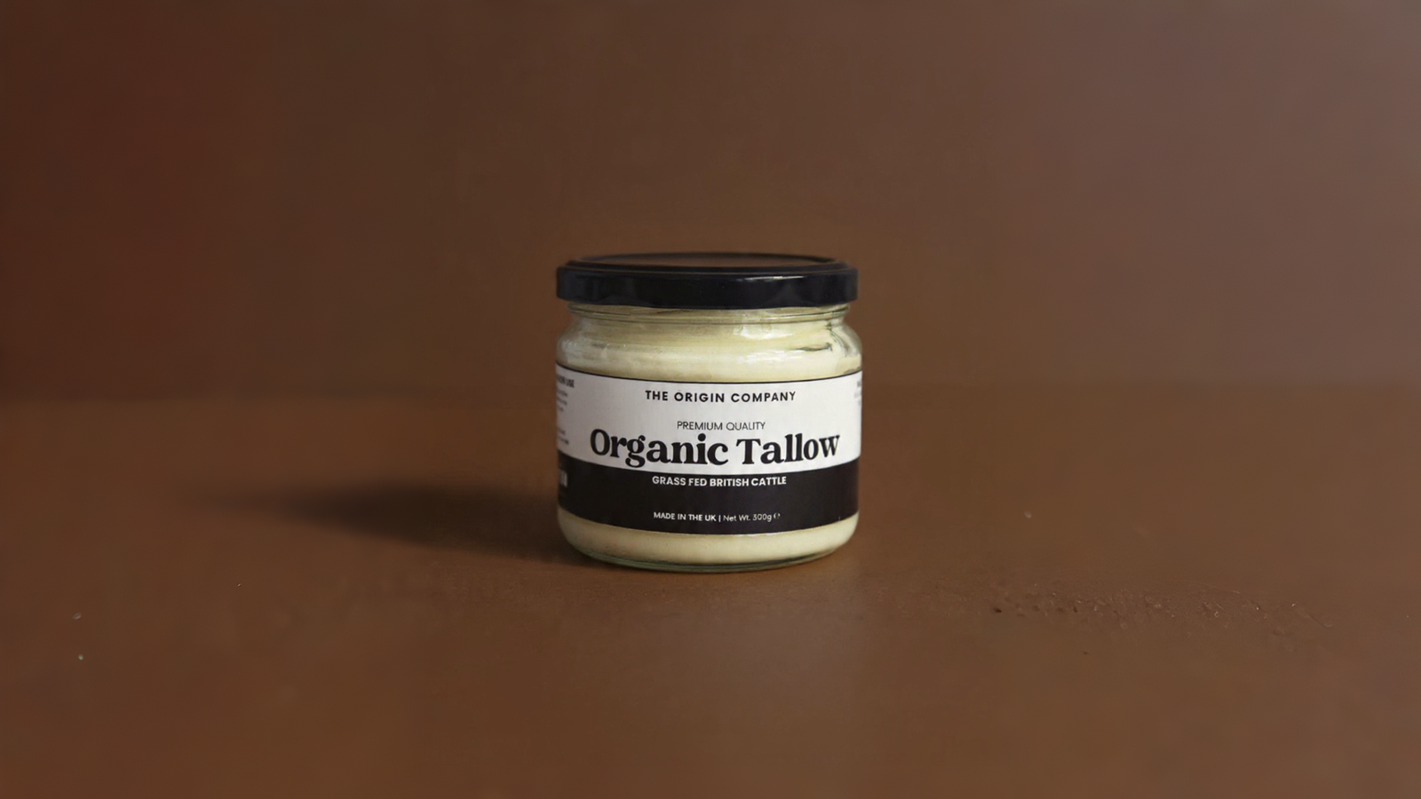 Laboratory workspace with pure white beef tallow block, beaker of melted golden tallow, cheesecloth, and glass test tubes